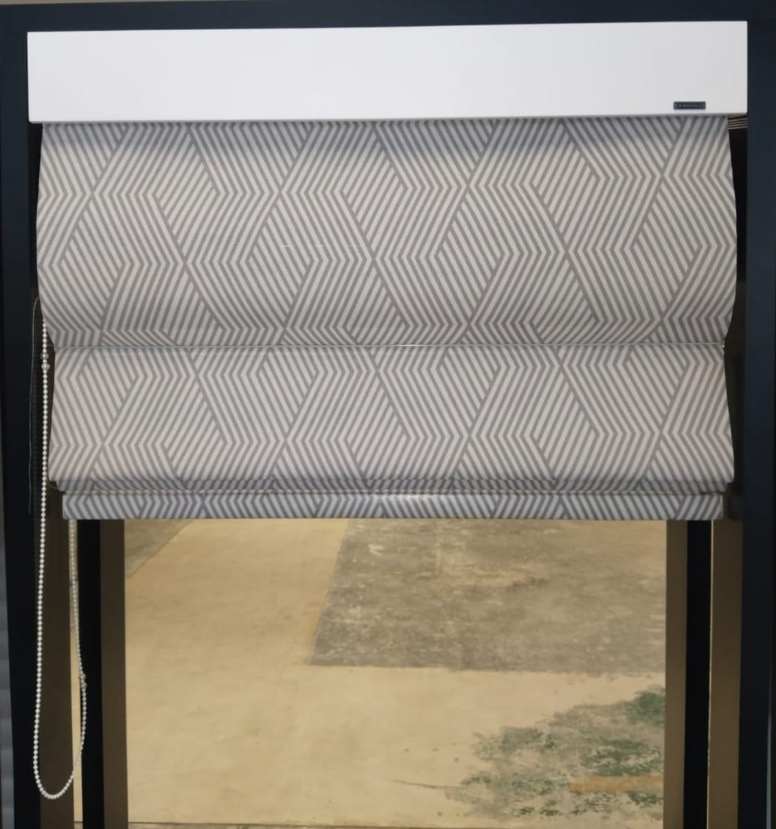 Roman blind in patterned fabric with a white pelmet