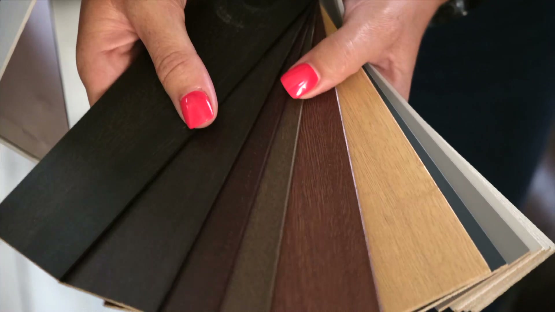 A fan of wood-grain and aluminium slat samples at Linric Blinds